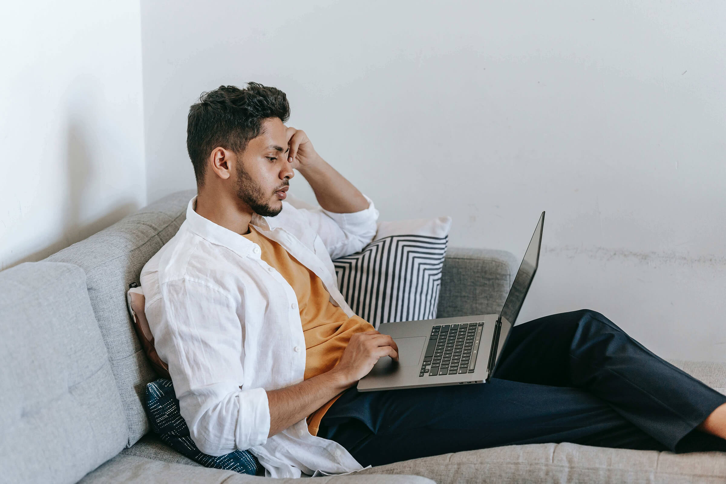 Man on couch talking to party planner