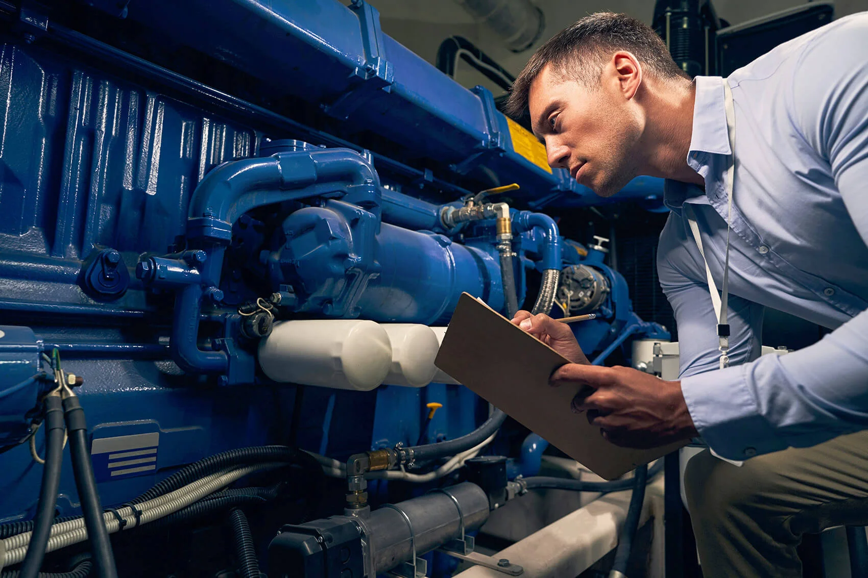 Worker Inspecting Diesel Generator
