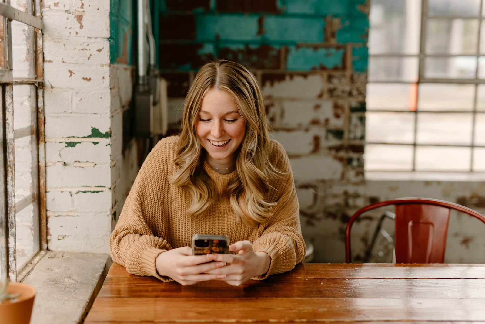 Smiling customer reading a post-event review request text message on her phone