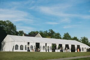 How to start a rental business: white event tent set up on a lawn for a wedding