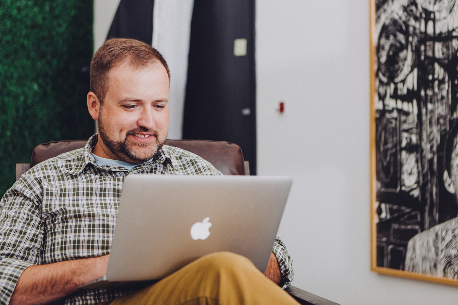 Rental business owner on a laptop checking customer survey results to catch an unhappy client before a negative review